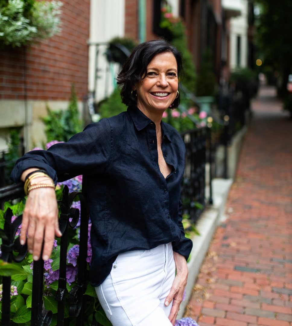 Jennifer Redmond leaning casually on a fence